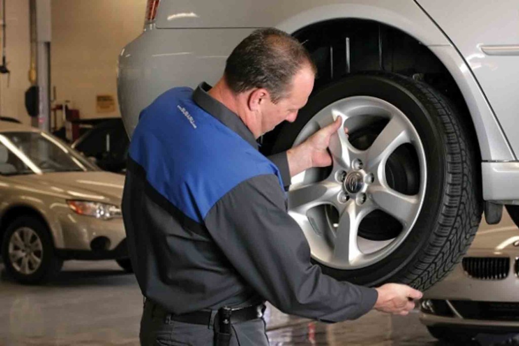man putting tire on